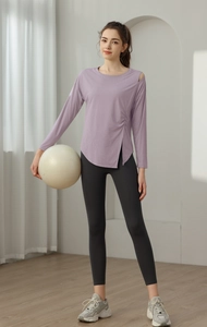 Detail of light purple yoga top with side slit and drawstring on breathable fabric