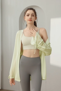 Detail of light green yoga jacket featuring adjustable drawstring cuffs and breathable fabric