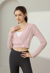 Pink cropped yoga top with deep V-neck cross-wrap design and breathable jacquard fabric