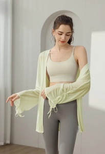 Detail of light green sun-protective yoga cover-up with drawstring ruched sleeve design