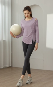 Detailed side view of lavender yoga top with side slit and drawstring ruching design