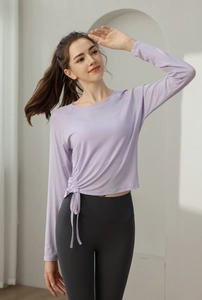 Detail of light purple yoga top with side drawstring design and breathable fabric texture