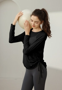 Detail of long sleeve sports top with adjustable side drawstring for yoga fitness
