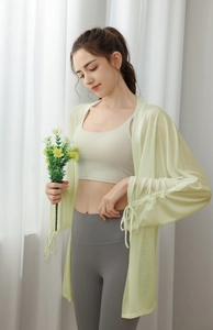 Detail of loose-fit green yoga cover-up jacket featuring adjustable drawstring cuffs