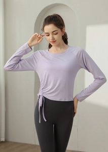Detail view of long-sleeve yoga top with side drawstring ruching in light purple