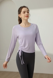 Close-up of slim-fit yoga top with side drawstring design and ruched details