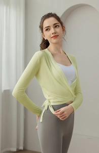 Detail of light green wrap yoga top with adjustable waist tie and V-neck design