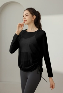 Detail of black long sleeve yoga top with adjustable side drawstring for fitness