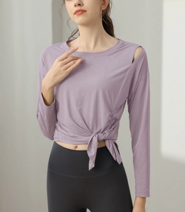 Detail view of light purple yoga top with side shoulder cutout and drawstring knot hem