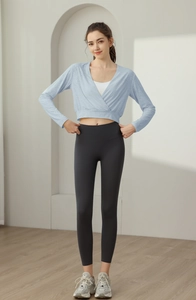 Detail of light blue wrap-front yoga top with premium textured nylon fabric