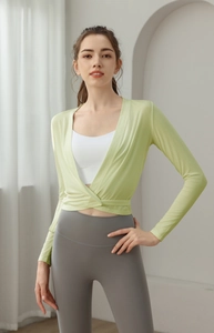 Detail showing the wrap V-neck design and slim fit of the light green yoga cardigan