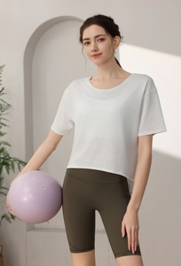 Close-up of a white loose-fit camouflage sports t-shirt paired with olive green yoga shorts