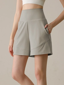High-waisted light grey yoga shorts with side pockets and quick-dry fabric for women