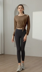 Detail of coffee brown yoga top with side tie knot and shoulder cutout design