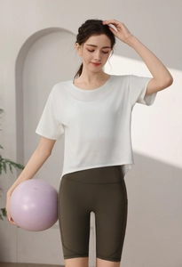 Detail of loose-fit white camouflage burnout sports tee and high-waist green yoga shorts