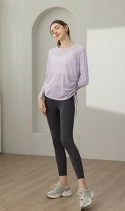 Detail of adjustable side drawstring on light purple mesh yoga cover-up top