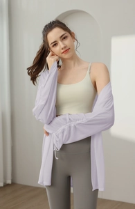Detail of lavender sheer yoga cover-up with drawstring cuffs and athletic layering