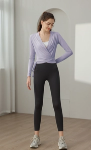 Detailed view of women's lilac wrap sports top and high waist black yoga leggings