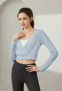 Detail of light blue wrap long sleeve yoga crop top featuring breathable jacquard fabric