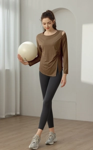 Detail view of brown yoga top with side slit and shoulder cut-out for fitness