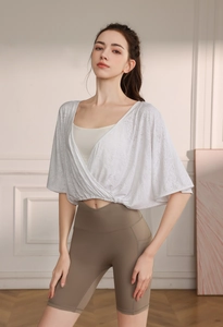 Detail of white hollowed-out jacquard yoga cover-up with breathable mesh texture