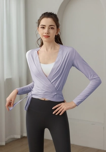 Detail of lavender wrap yoga top with elegant V-neck cross design and breathable fabric