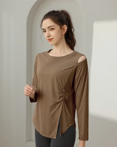 Detail of coffee brown long sleeve yoga top featuring side drawstring and slit design