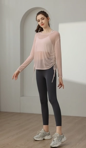 Detail of pink mesh yoga cover-up showing the adjustable side drawstring and sheer fabric