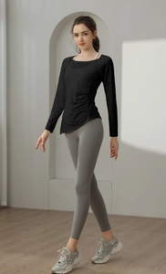 Detail of slim fit black jacquard yoga top with ruched side and asymmetrical hem design