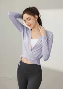 Detailed close-up of light purple wrap-around yoga top with side tie and soft V-neckline