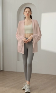 Detail of light pink yoga cover up with adjustable drawstring cuffs and sheer texture