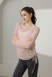 Detail of pink long sleeve yoga cover-up featuring side drawstring and breathable fabric