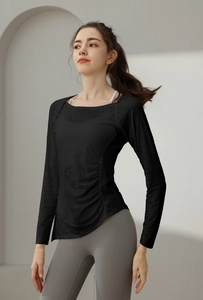 Detail of slim-fit black nylon jacquard yoga top featuring side drawstrings and ruching