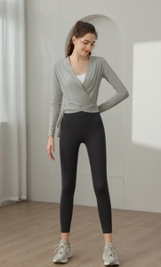Detail of slim fit light green wrap yoga top and black high waisted leggings set