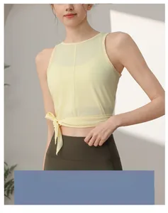 Detail eines gelben Mesh-Yoga-Tops mit modischem seitlichem Bindedetail am Saum