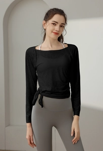 Detail of black long-sleeve sports top with square neck and side tie decorative strings