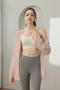 Detail of light pink mesh yoga cover-up with drawstring cuffs and sports bra