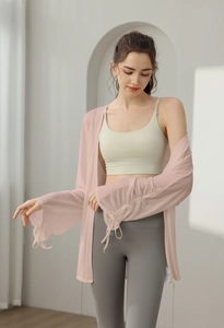 Detail of light pink mesh yoga jacket with drawstring cuffs for a breathable fitness look