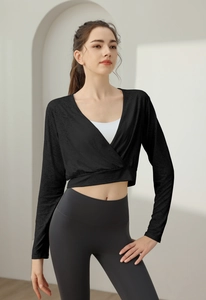 Detail of a black long-sleeve yoga cover-up with a deep V-neck cross design for fitness