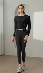 Detail of black long sleeve yoga top with shoulder cutout and stylish side tie knot