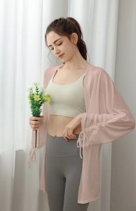 Detail of light pink yoga cover-up showing breathable thin fabric with pleated texture