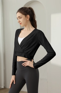 Detail of cross-front long sleeve yoga top with V-neck layered over white sports bra