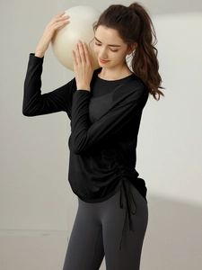 Women's long sleeve workout top and leggings set with side drawstrings and yoga ball