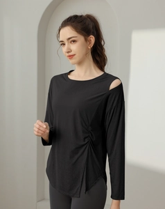 Detail of black yoga top with shoulder cutout and ruched asymmetric side slit
