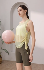 Detail view of mesh yoga tank top with side drawstring and olive green biker shorts