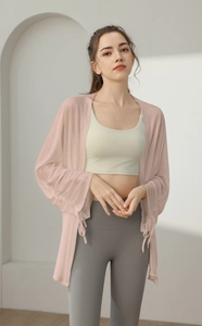Detail view of pink mesh yoga cover-up with drawstring cuffs and breathable texture