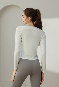 Slim fit white yoga top and grey leggings with drawstring side detail from a back view