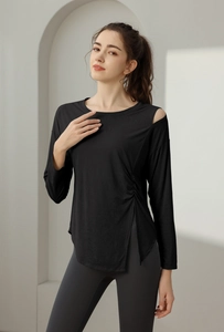 Detail of black sports top featuring shoulder cutout and side drawstring slit design