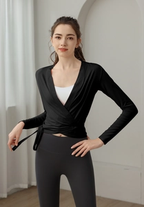 Detail of slim fit wrap-style yoga top with cross tie design for workout waist shaping