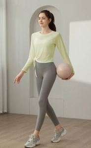 Detail of slim fit yoga top with side drawstring design and breathable knit fabric